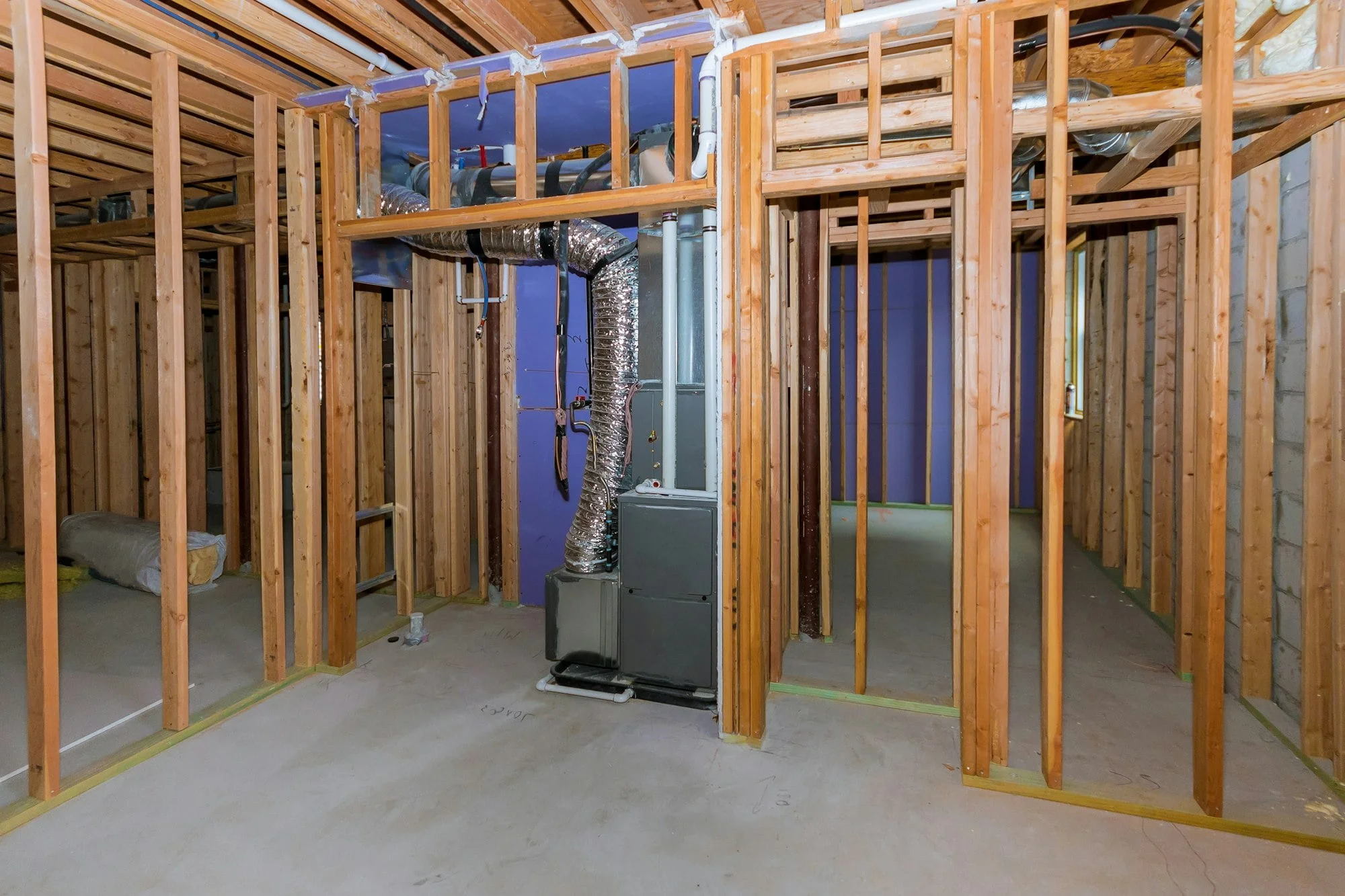 The basement of a building under construction is filled with dirty flood water